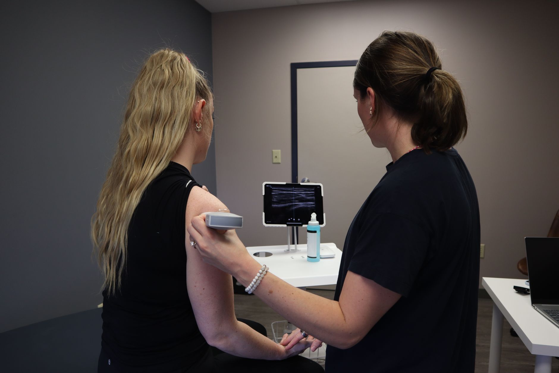 Nurse practitioner evaluating a patient for an urgent care visit in California