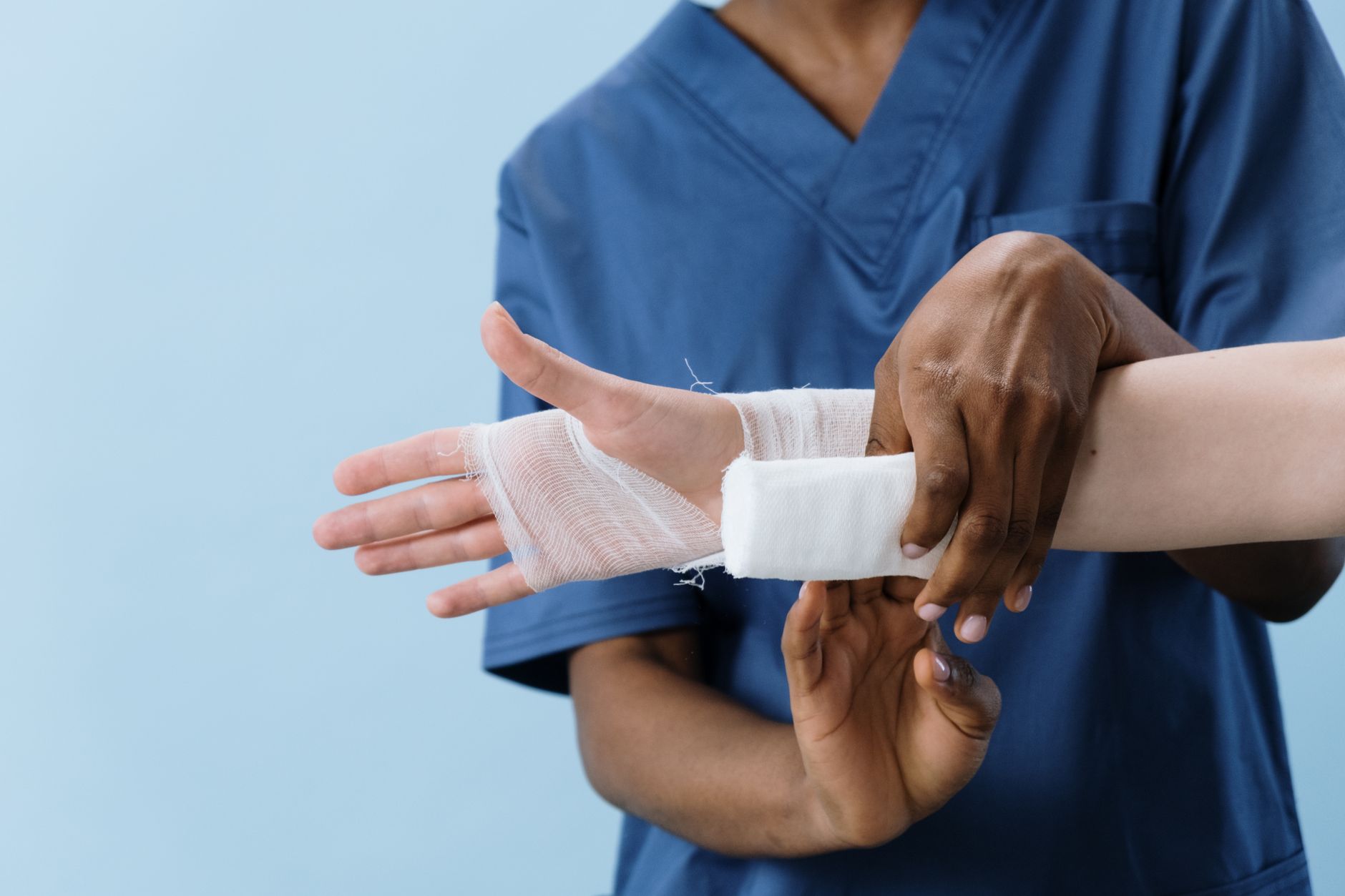 Nurse practitioner dressing a patient's wound during a wound care visit in California