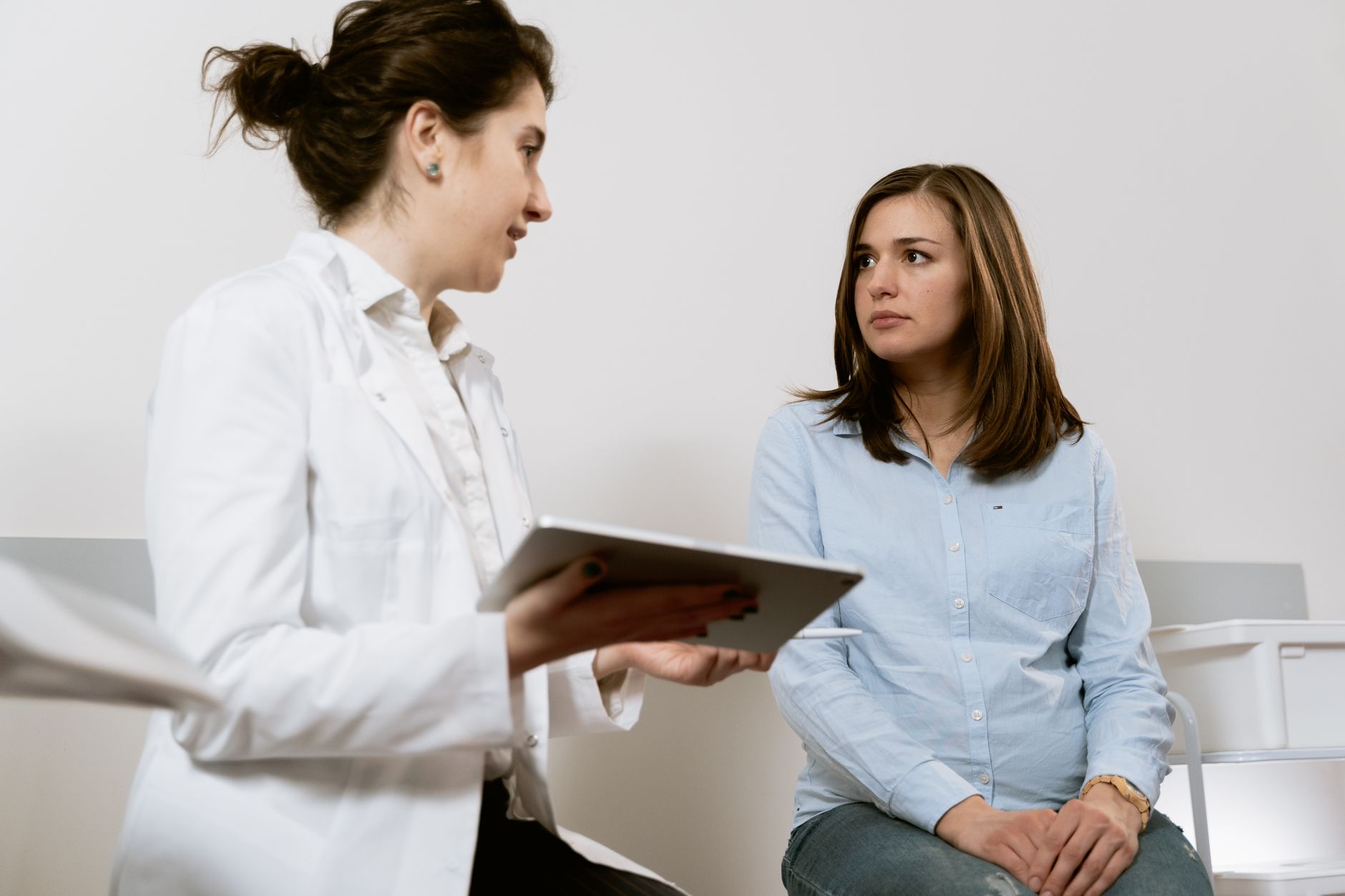 Nurse practitioner consulting with a patient about women's health care