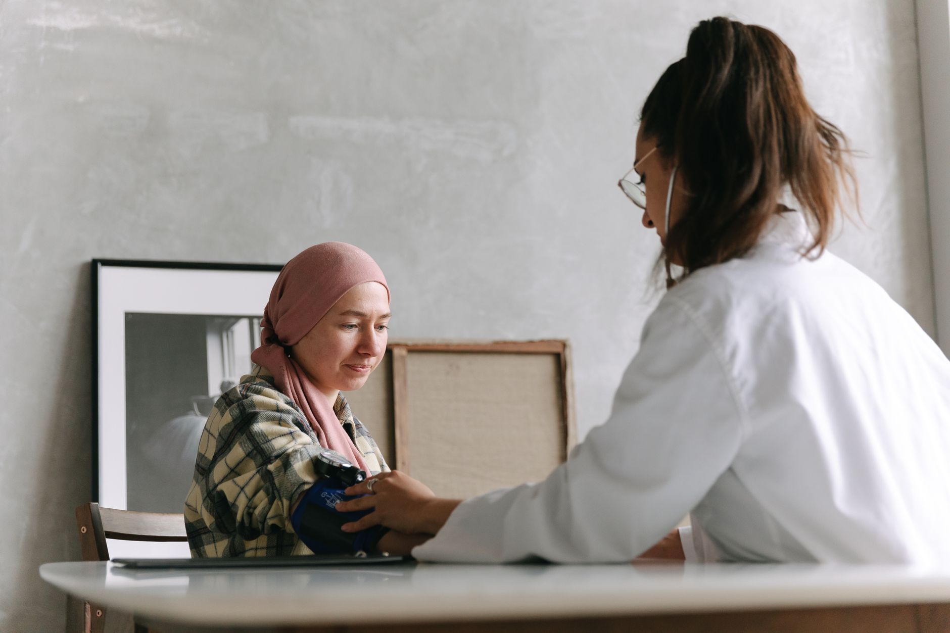 Nurse practitioner checking a patient's blood pressure during a primary care visit in California